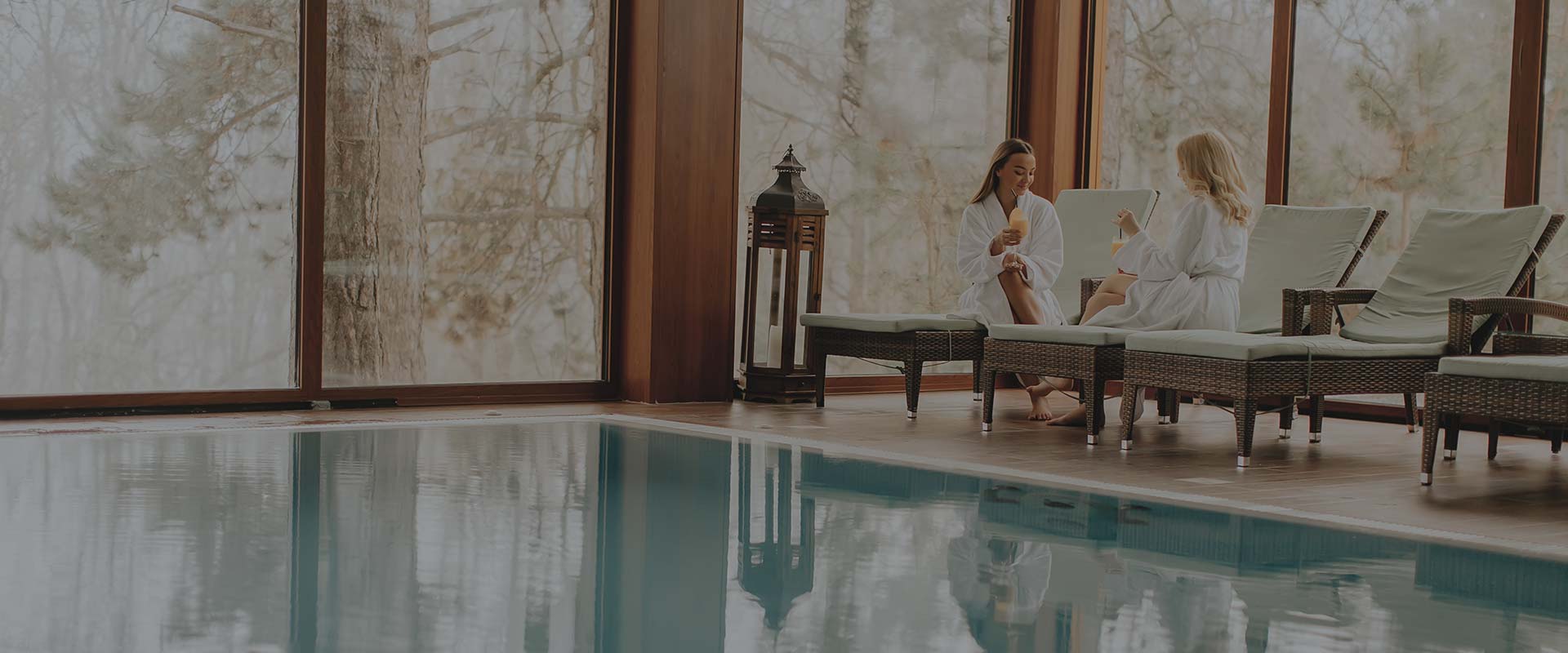 A woman sitting in front of a pool