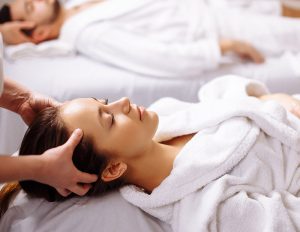 A woman laying down with her eyes closed.