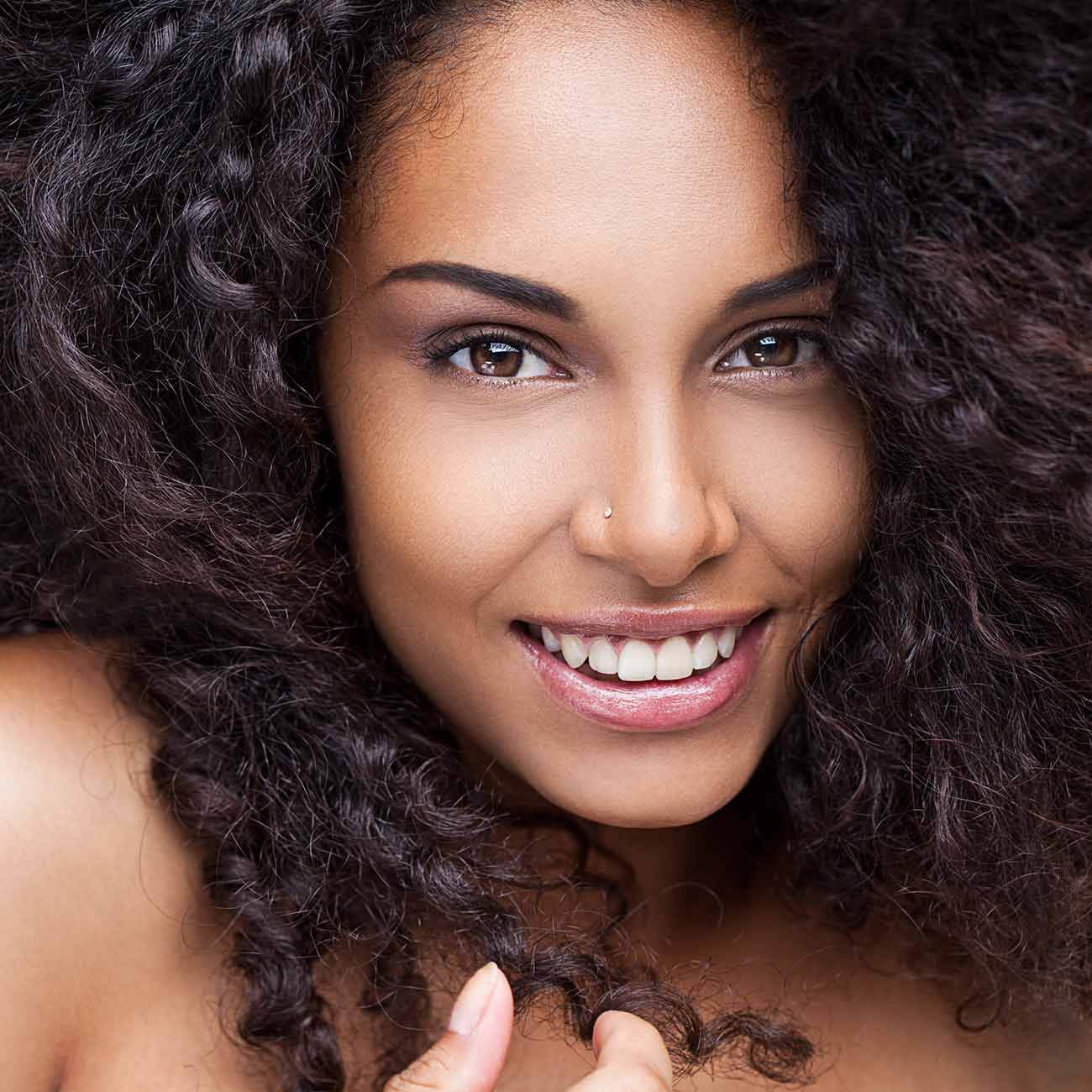 A woman with long hair smiling for the camera.