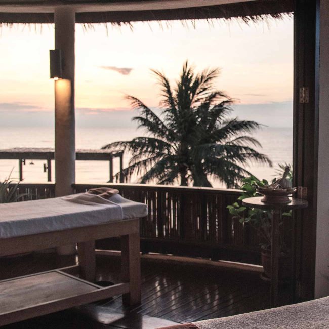 A view of the ocean from an outdoor dining area.