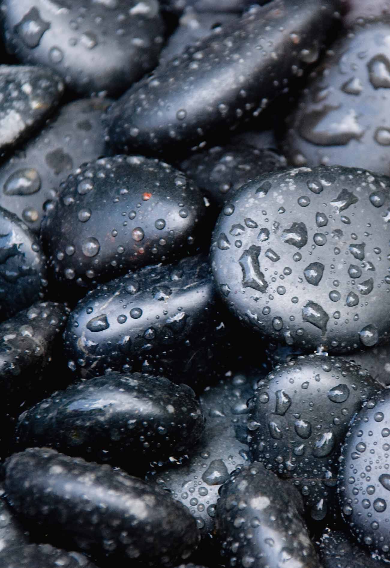 A close up of water drops on some rocks