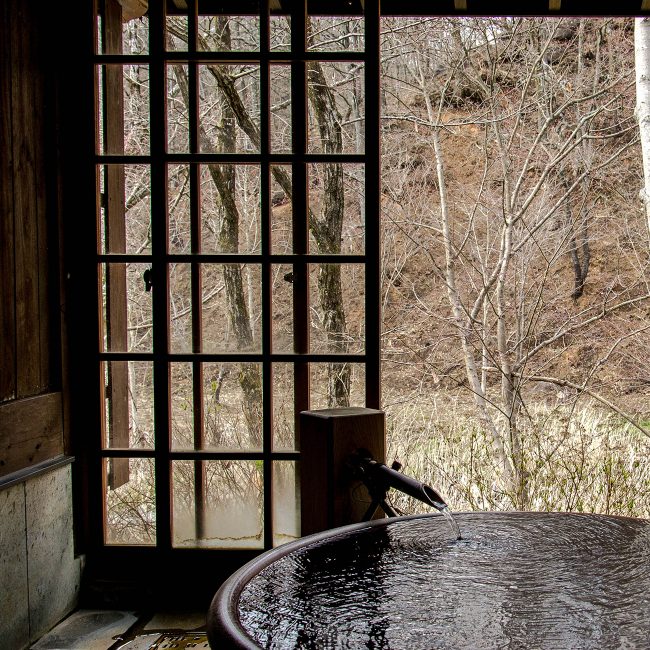 A view of a window and the outside of a building.