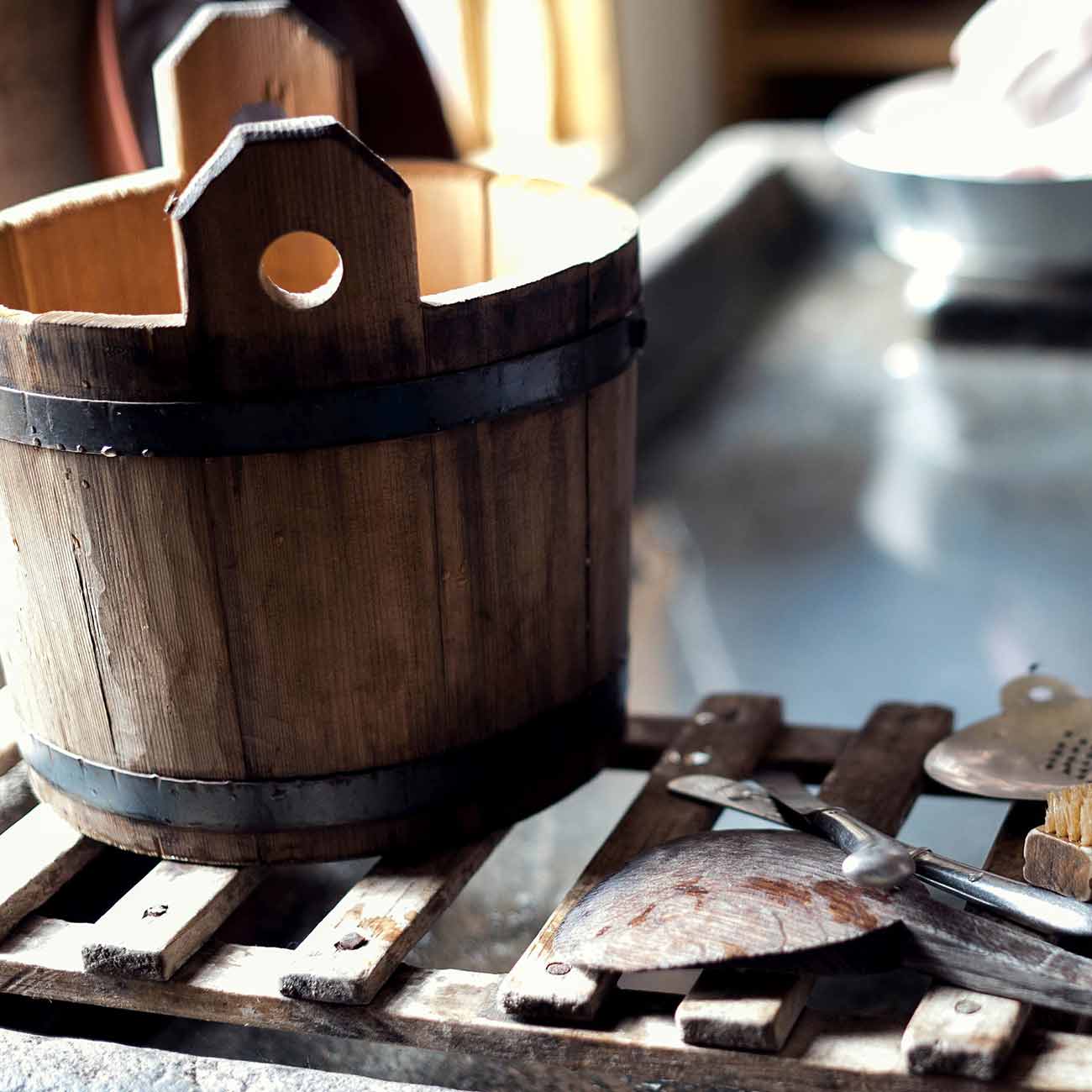 A wooden bucket sitting on top of a table.