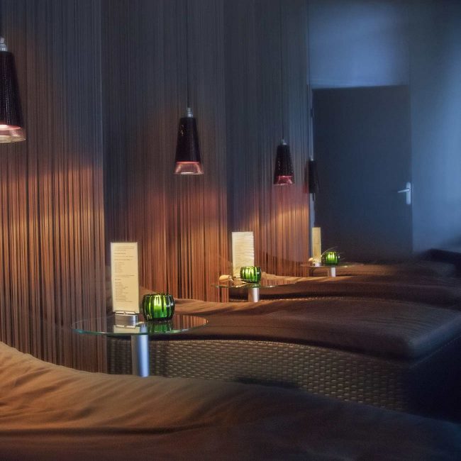 A room with several lamps and beds in it