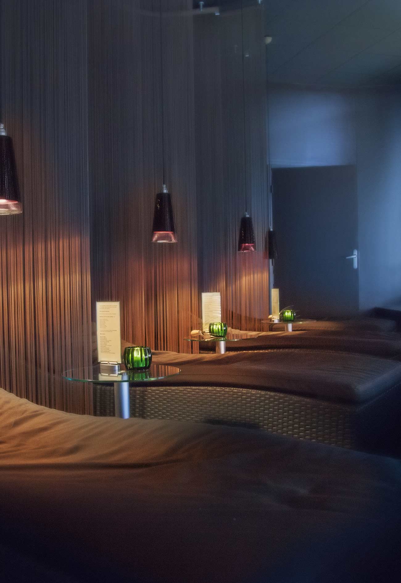 A room with several lamps and beds in it