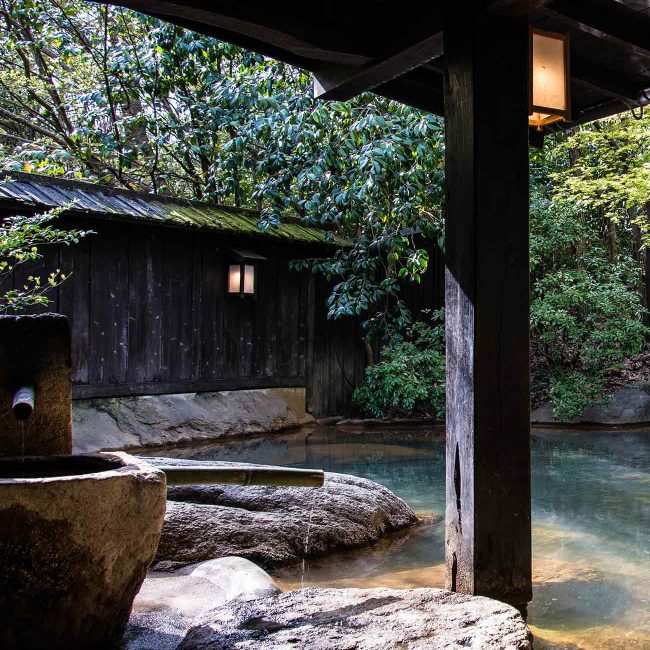 A wooden structure sitting in the middle of a river.
