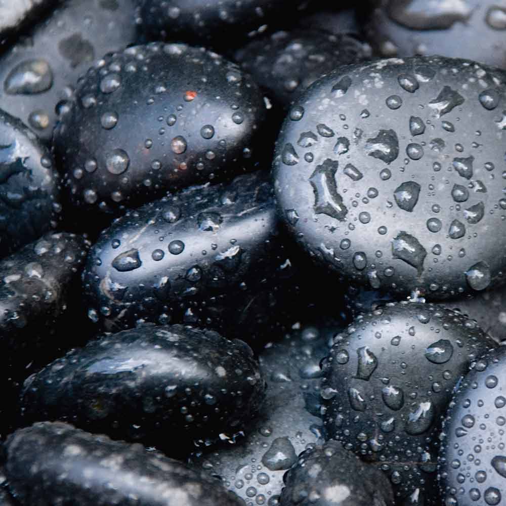 A close up of water drops on some rocks
