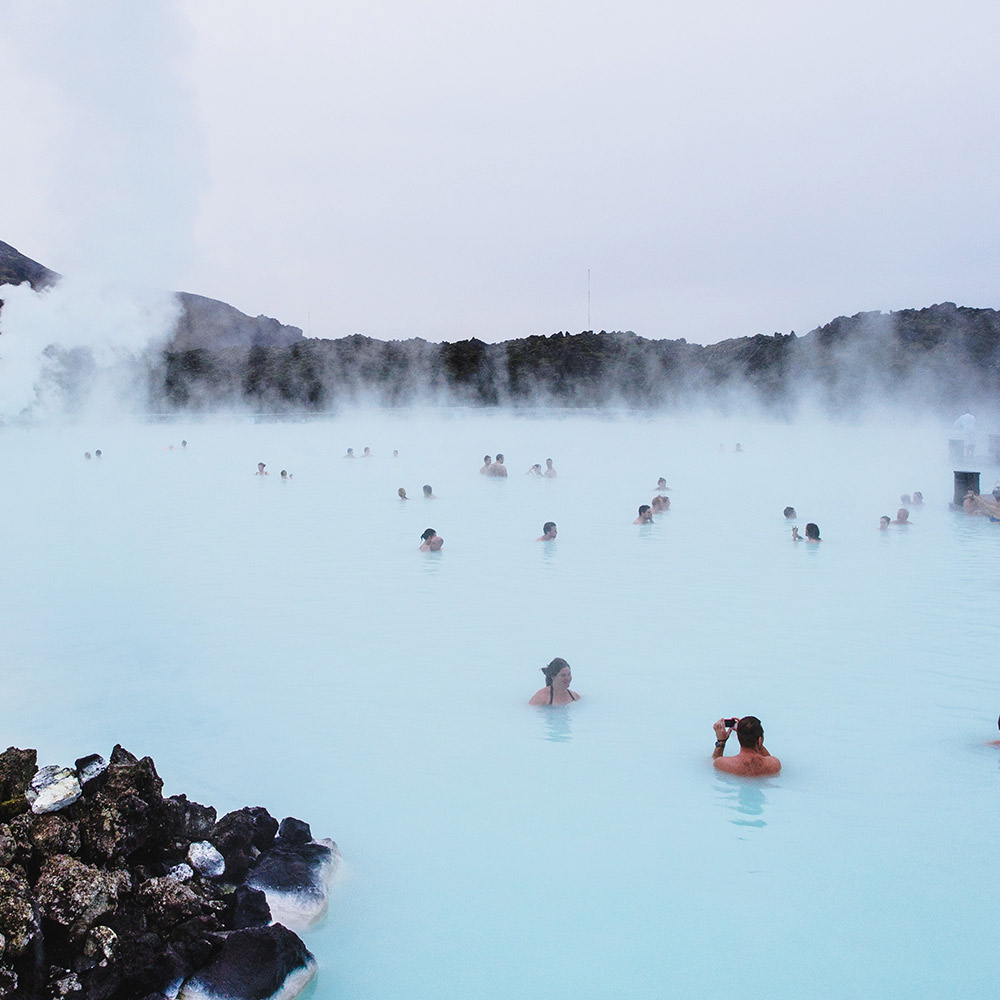 A group of people in the water at a hot spring.