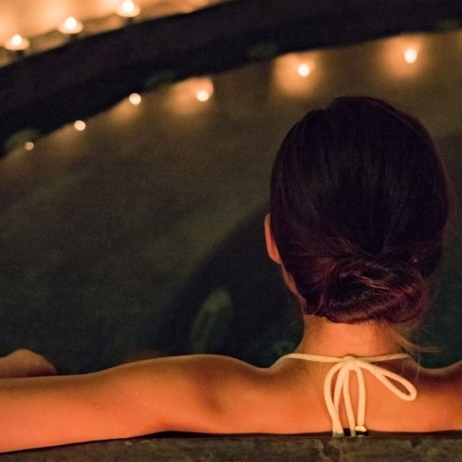 A woman sitting in the middle of a pool.