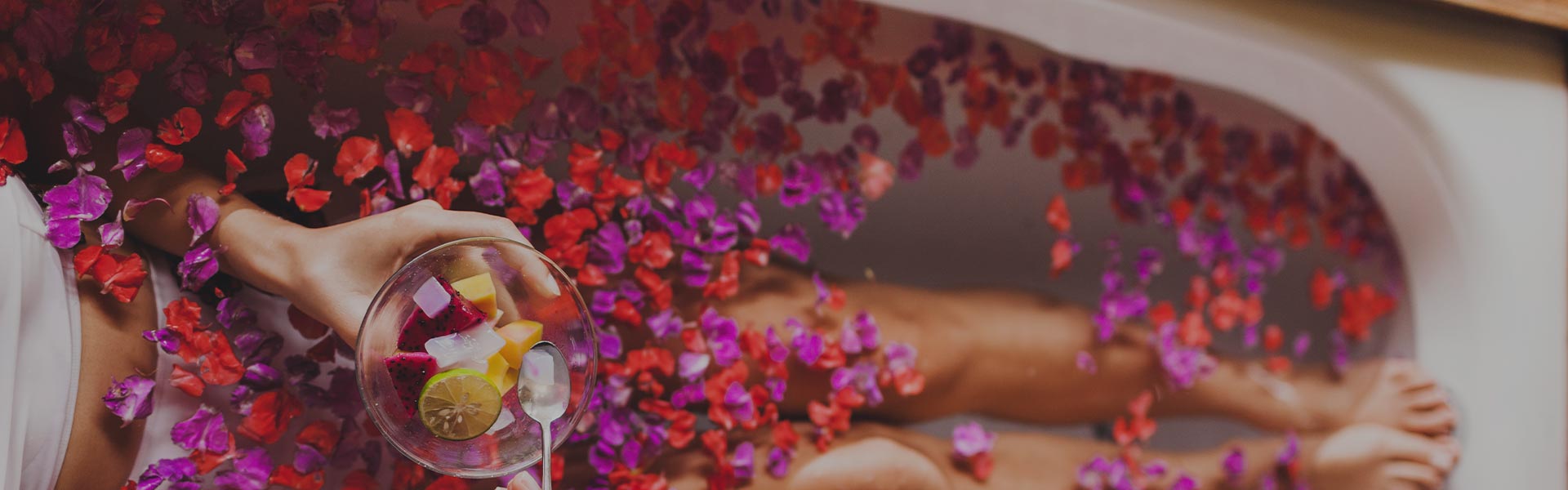 A person is sitting under an umbrella with flowers.