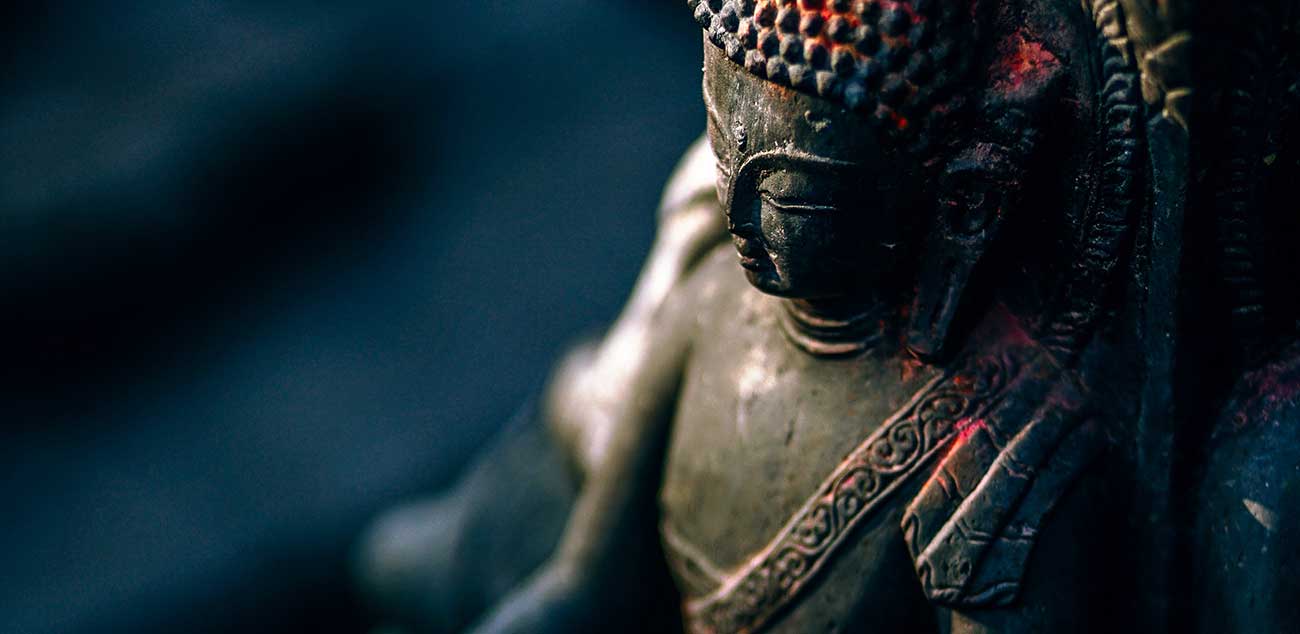 A close up of the face of a buddha statue.