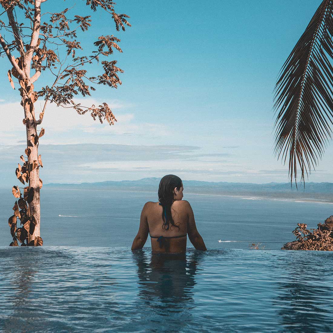 A woman sitting in the middle of a pool.