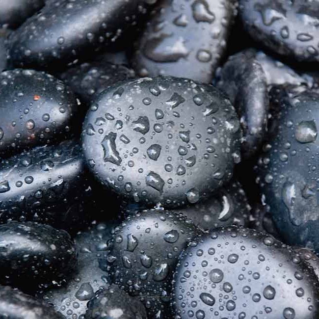 A close up of water drops on some rocks