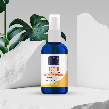 A bottle of oil is sitting on the rocks.